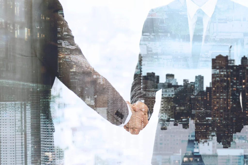 How Small Businesses Can Scale in a Digital World corporate business handshake between business partners